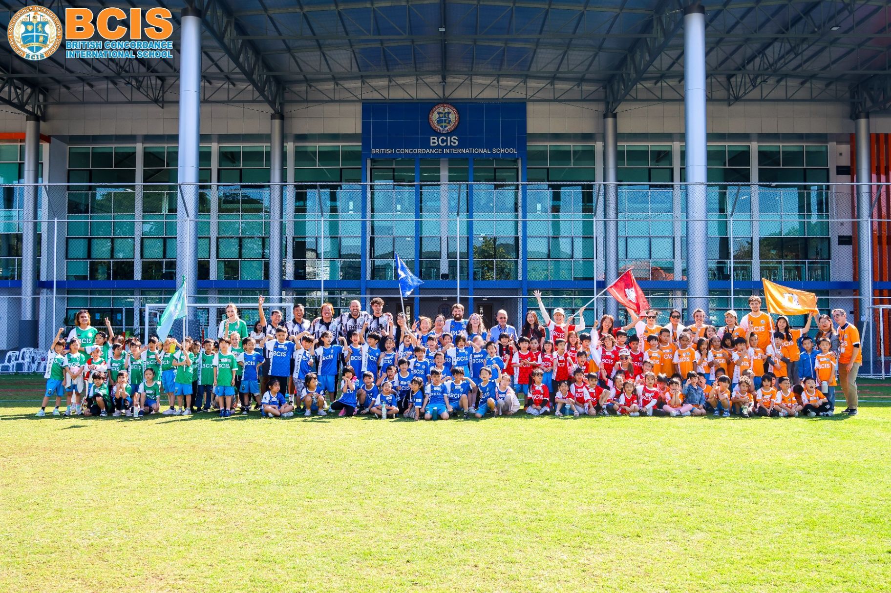 The whole BCIS school community gathered on the field in front of the main building