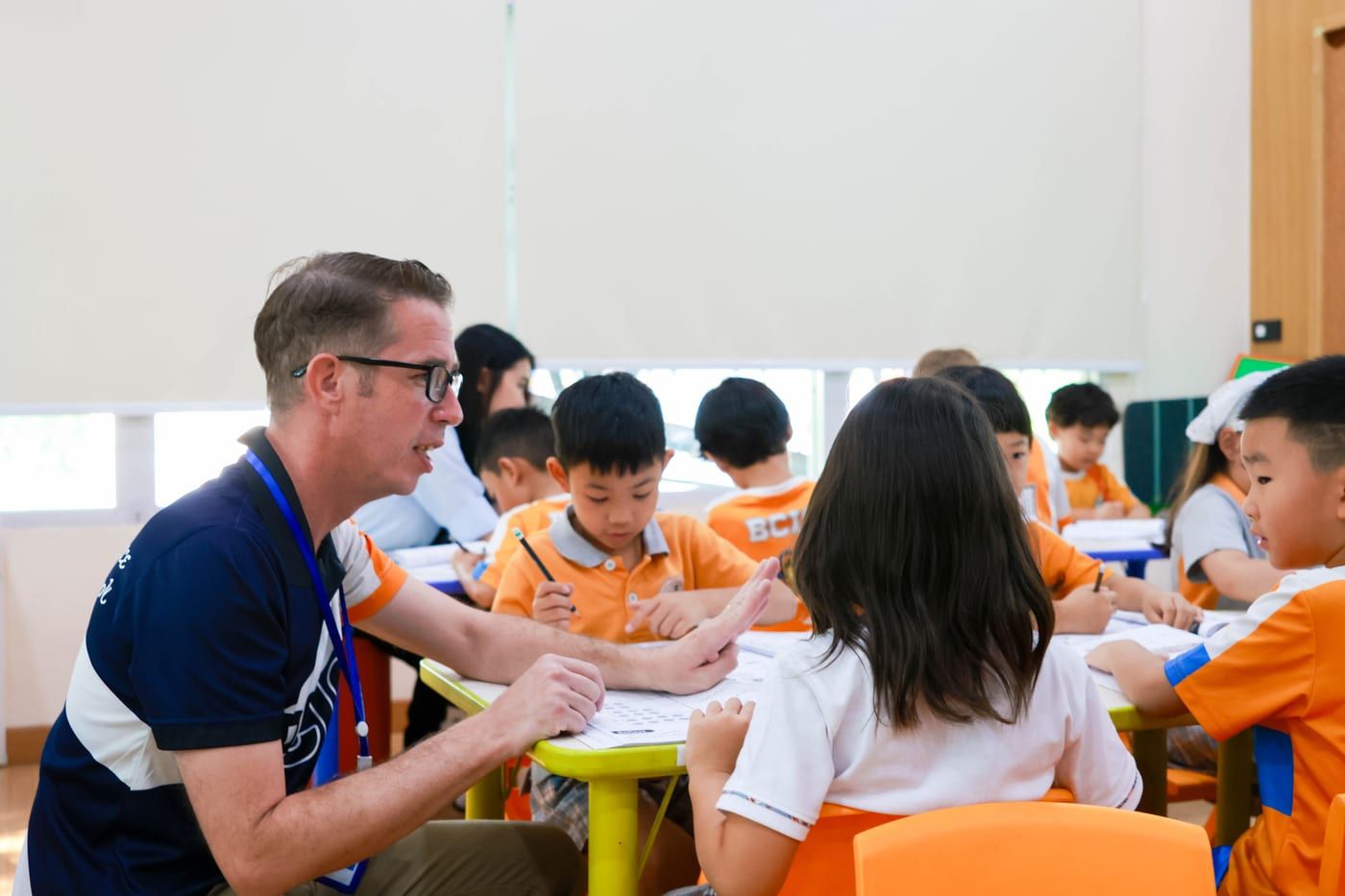 A BCIS Primary teacher working with his class at their desks